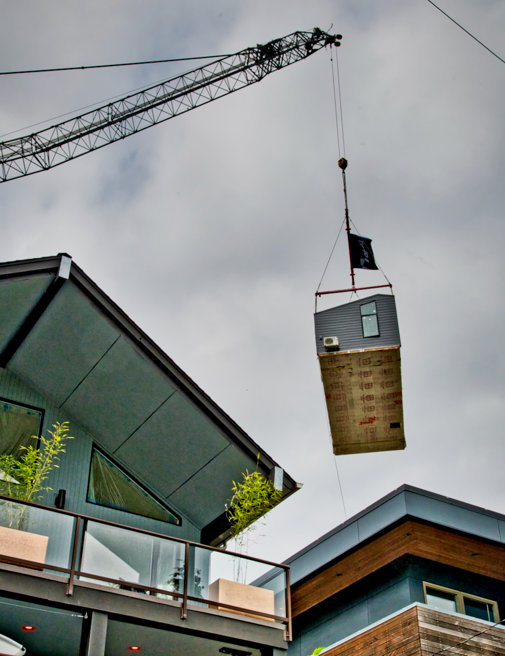 Backyard cottage lifted by crane into Gatewood backyard Westside Seattle